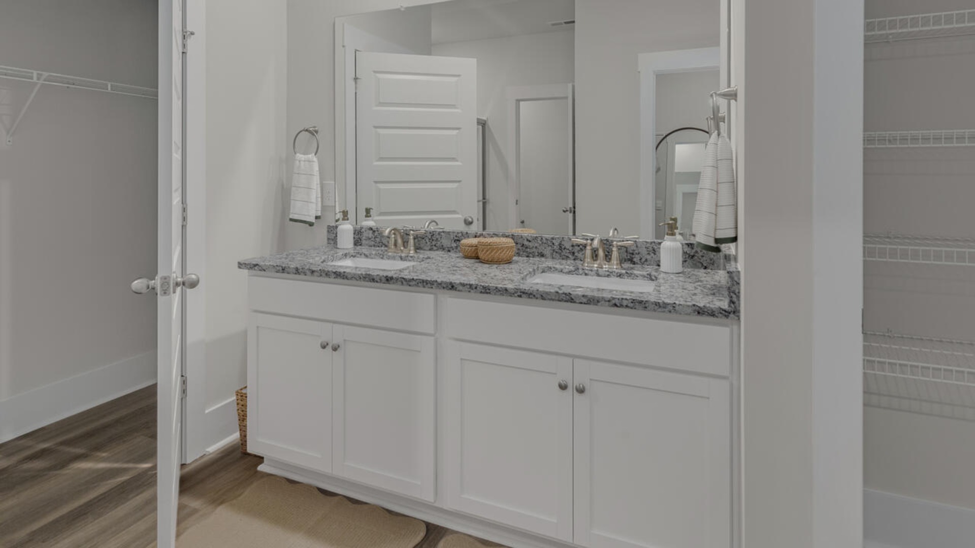 The spacious primary bedroom has a walk-in closet, garden tub, and double bowl vanities