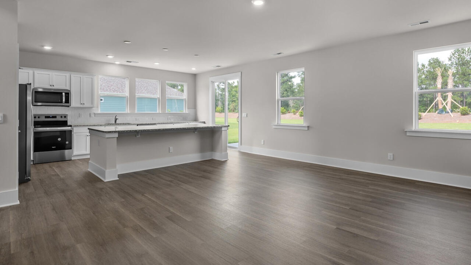 Featuring a formal dining room adjoining the kitchen, large island, and open concept living space.
