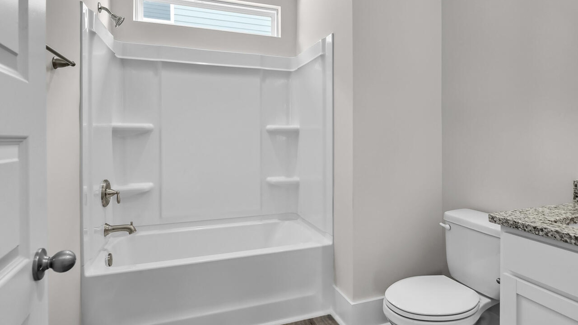 The primary suite features a sitting room, walk-in closet, trayed ceiling, a step-in 5-foot shower, dual vanity with granite countertops, and natural light in the bathroom.