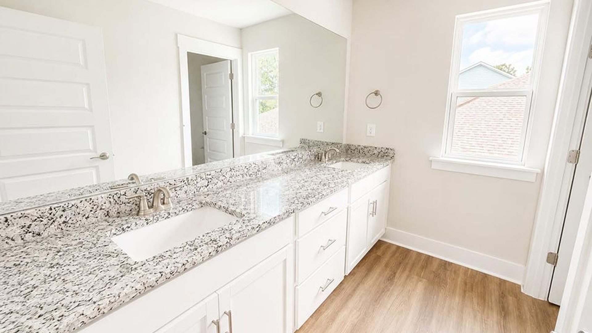 The main level is uniquely designed with a private secondary bedroom (Bedroom 2) located away from the main living traffic, making it an ideal guest suite or quiet home office