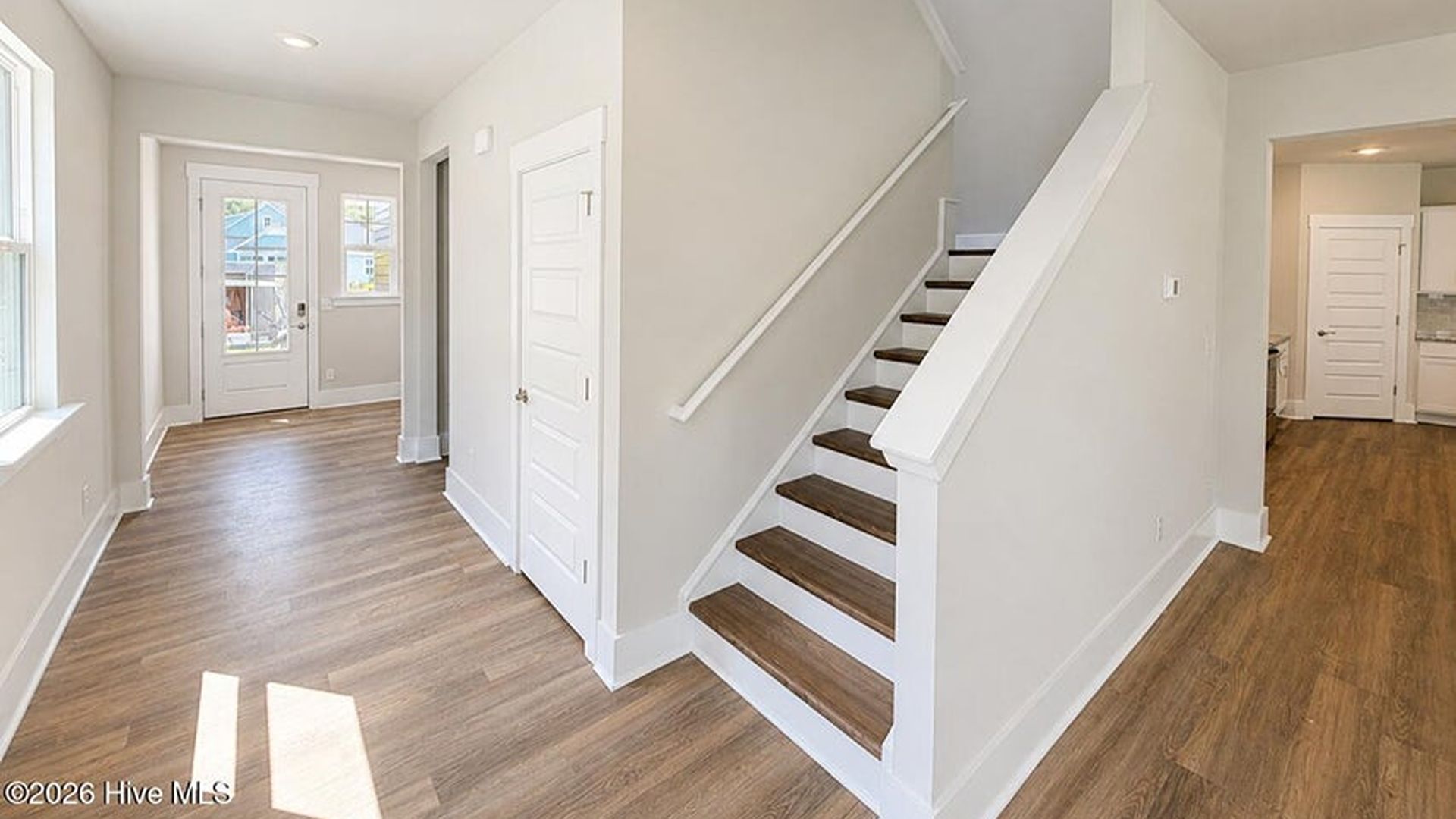 The main level is uniquely designed with a private secondary bedroom (Bedroom 2) located away from the main living traffic, making it an ideal guest suite or quiet home office
