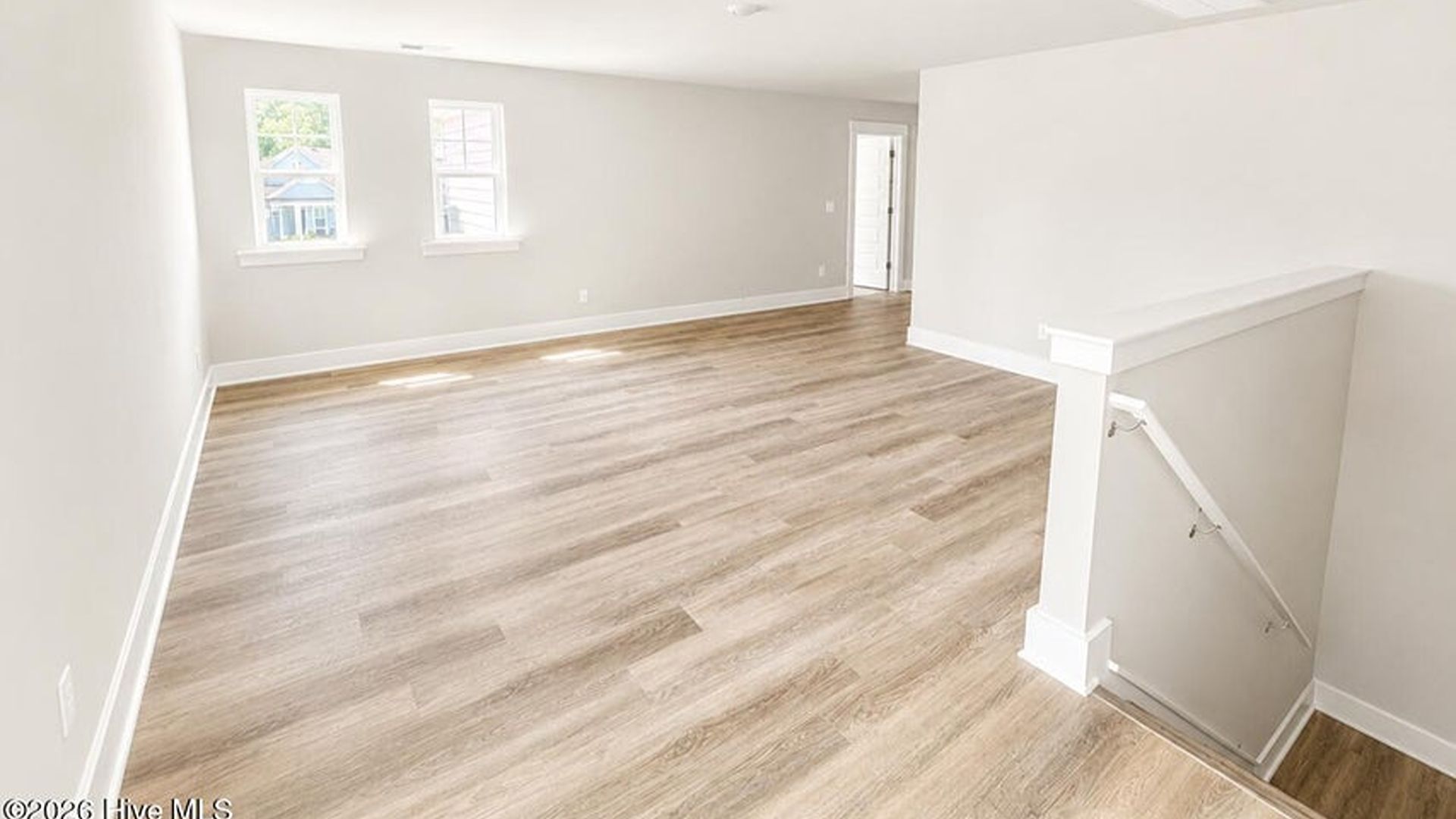 The main level is uniquely designed with a private secondary bedroom (Bedroom 2) located away from the main living traffic, making it an ideal guest suite or quiet home office