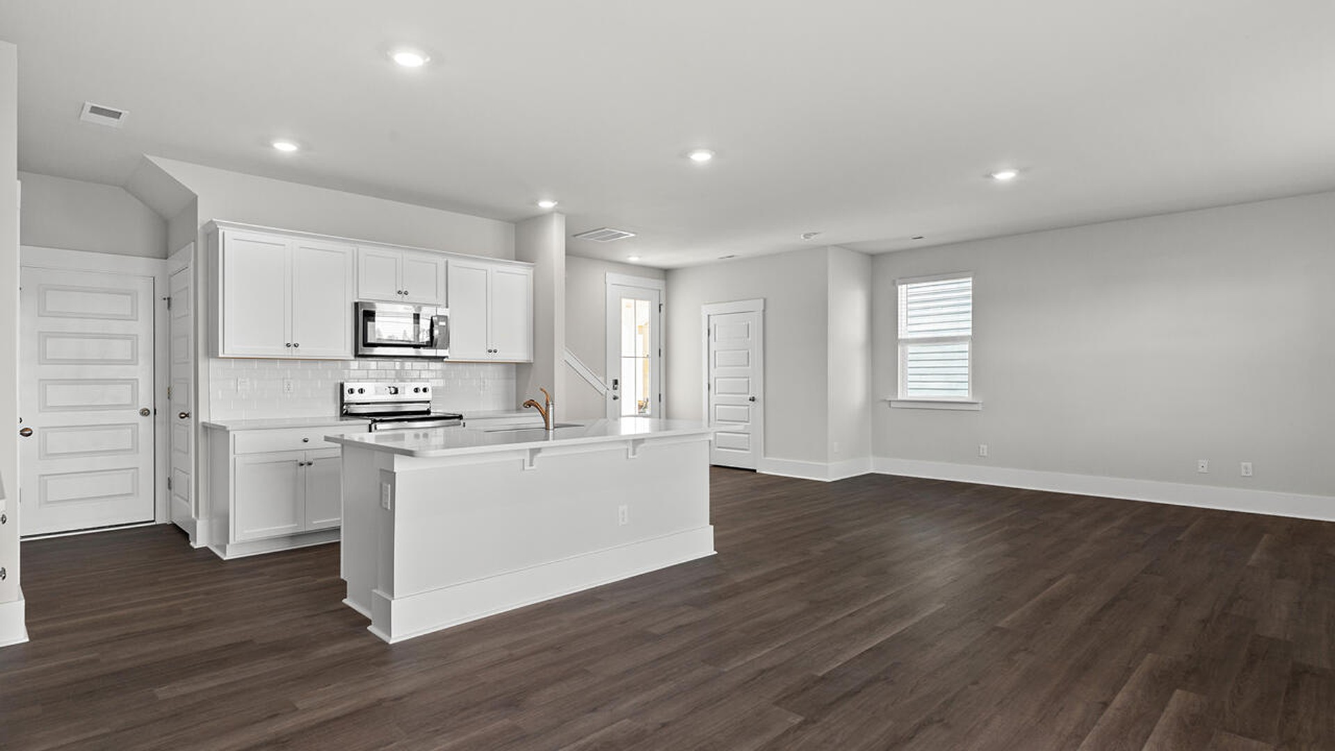 This new home features 9 ft. ceilings, beautiful quartz kitchen countertops, granite countertops in the two full bathrooms, luxury vinyl plank flooring throughout the first floor of the home, and a cozy screen porch!