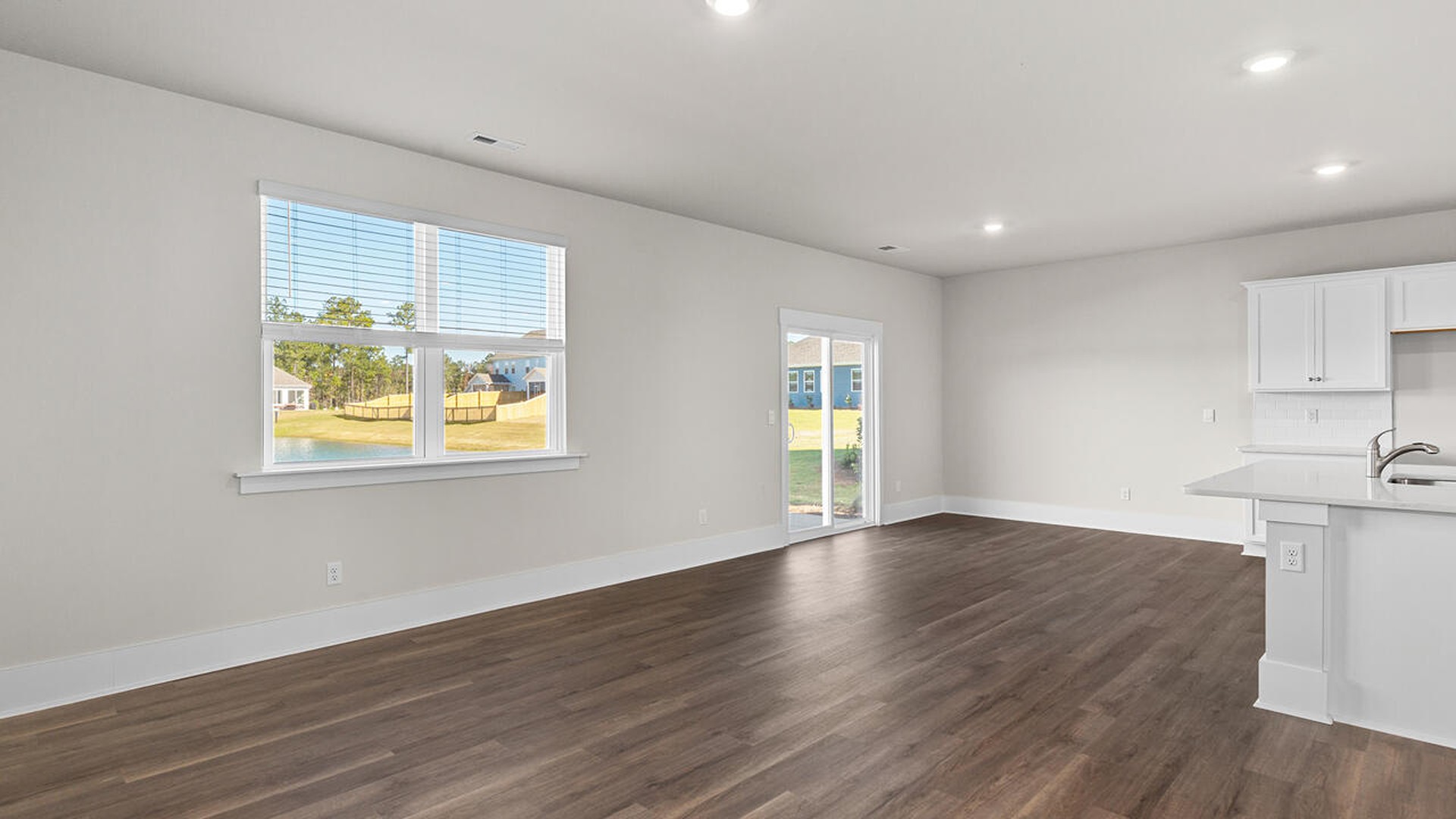 This new home features 9 ft. ceilings, beautiful quartz kitchen countertops, granite countertops in the two full bathrooms, luxury vinyl plank flooring throughout the first floor of the home, a cozy screen porch looking over an Amazing Pond!