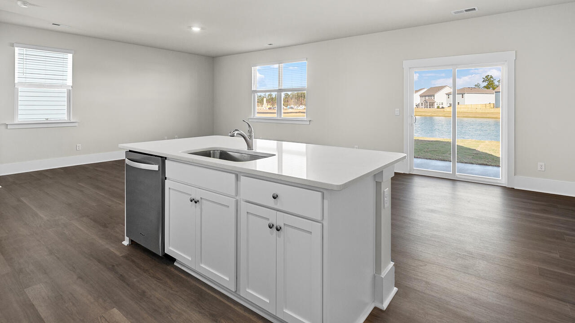 The kitchen features shaker-style cabinets, quartz countertops, and stainless steel appliances, which are sure to both turn heads and make meal prep easy. You’ll never be too far from the action with the living and dining area right there.