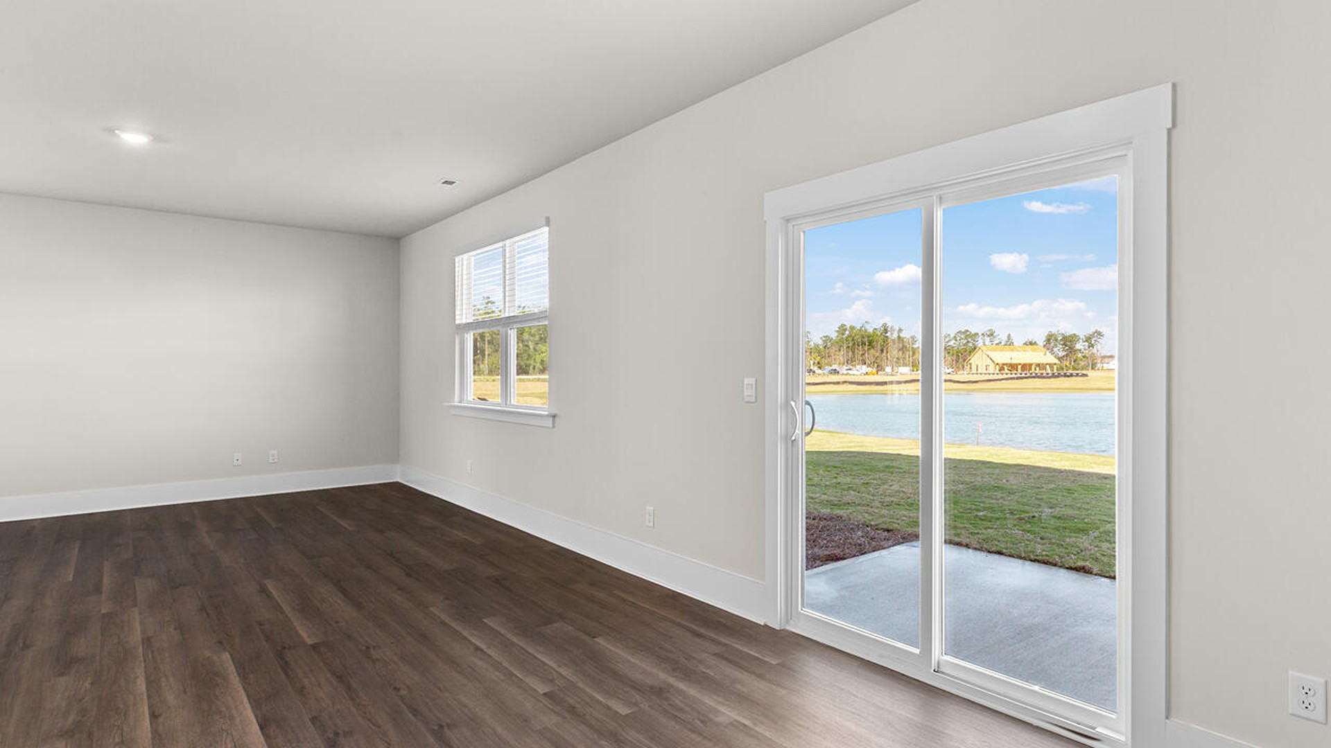 This new home features 9 ft. ceilings, beautiful quartz kitchen countertops, granite countertops in the two full bathrooms, luxury vinyl plank flooring throughout the first floor of the home, a cozy screen porch looking over an Amazing Pond!