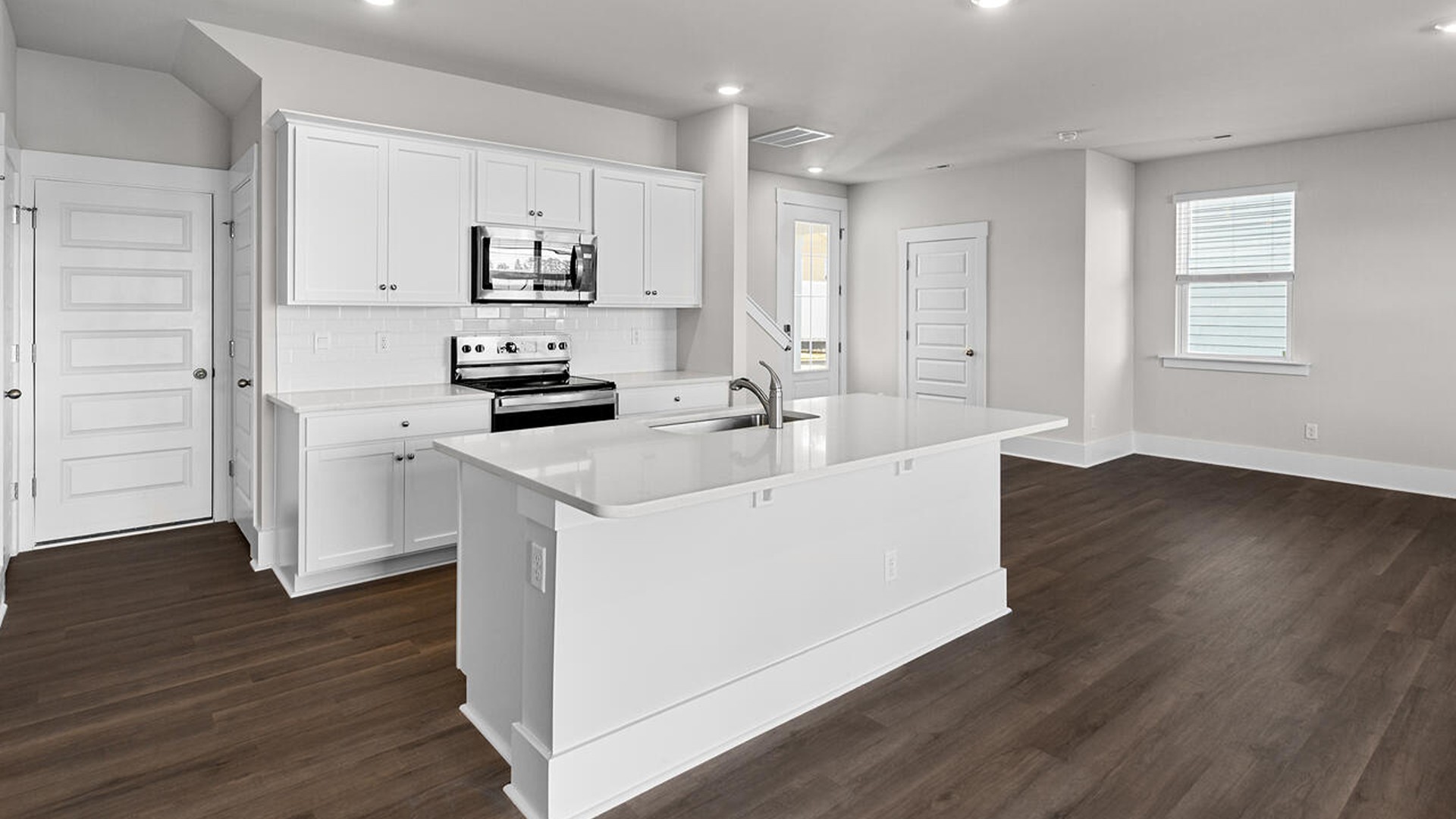 This new home features 9 ft. ceilings, beautiful quartz kitchen countertops, granite countertops in the two full bathrooms, luxury vinyl plank flooring throughout the first floor of the home, and a cozy screen porch!