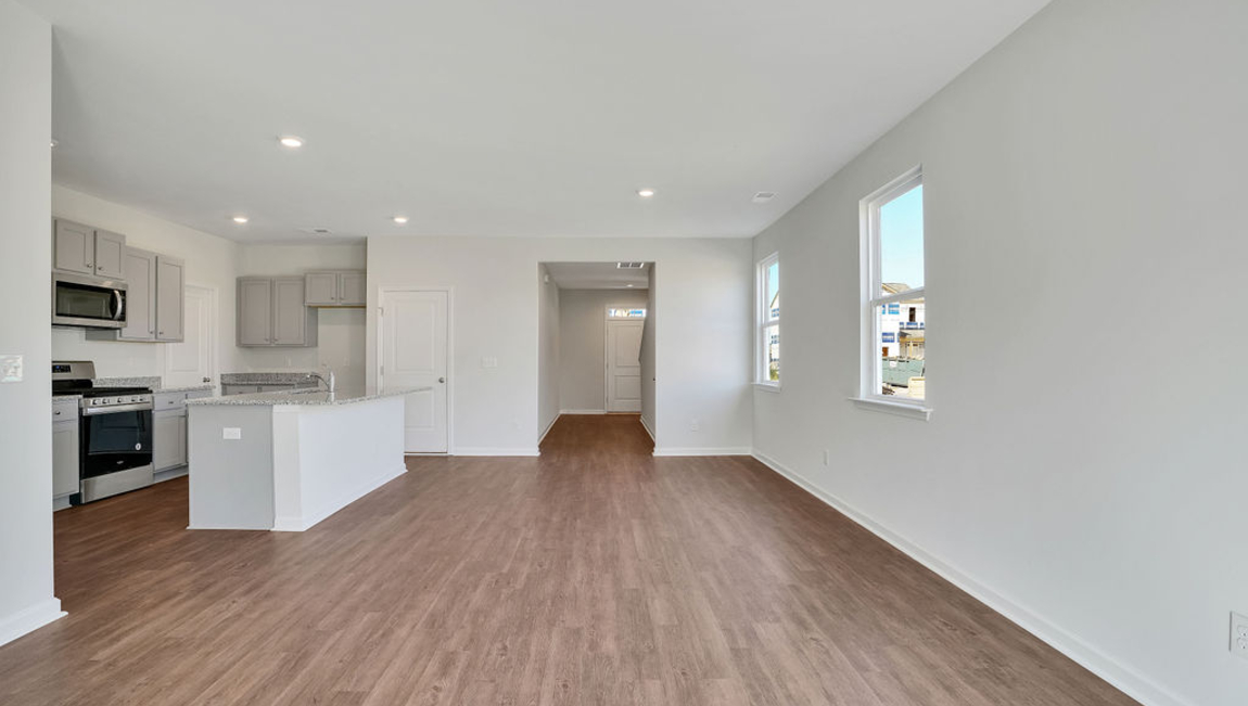 This new home kitchen features Stainless Steel Appliances, granite countertops and smooth-top electric range, microwave and dishwasher. Plenty of cabinet space.