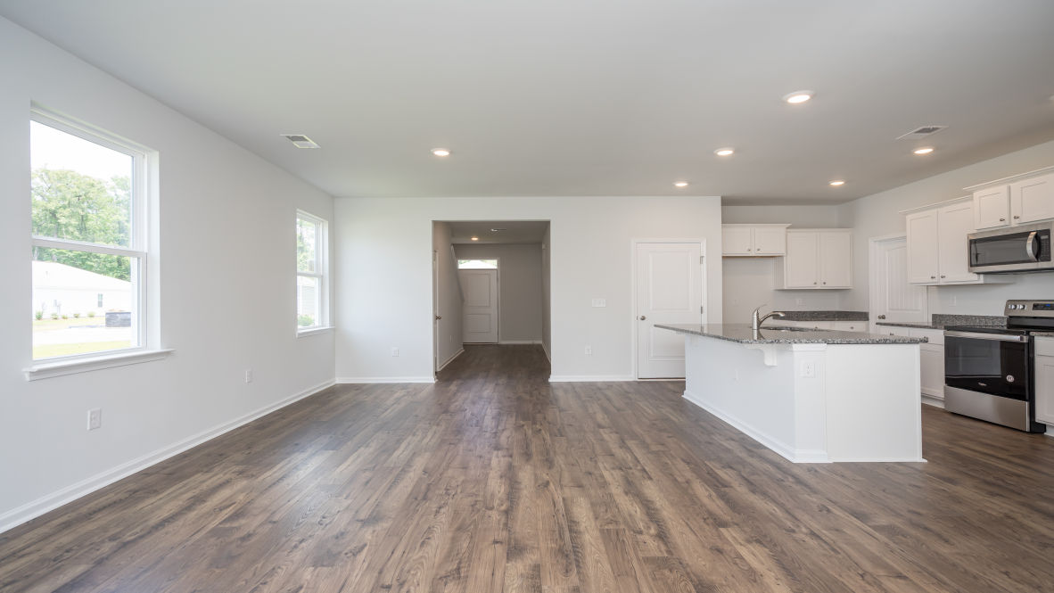 This new home kitchen features Stainless Steel Appliances, granite countertops and smooth-top electric range, microwave and dishwasher. Plenty of cabinet space.