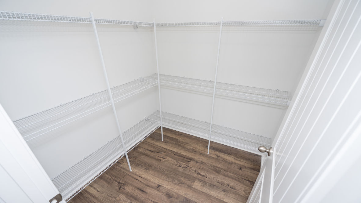 This new home kitchen features Stainless Steel Appliances, granite countertops and smooth-top electric range, microwave and dishwasher. Plenty of cabinet space.