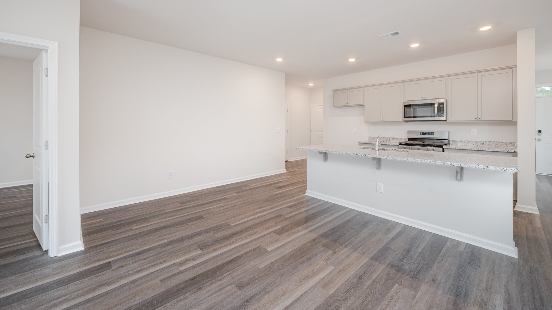 The kitchen features shaker-style cabinets, granite countertops, and stainless steel appliances, which are sure to both turn heads and make meal prep easy. You’ll never be too far from the action with the living and dining area right there.