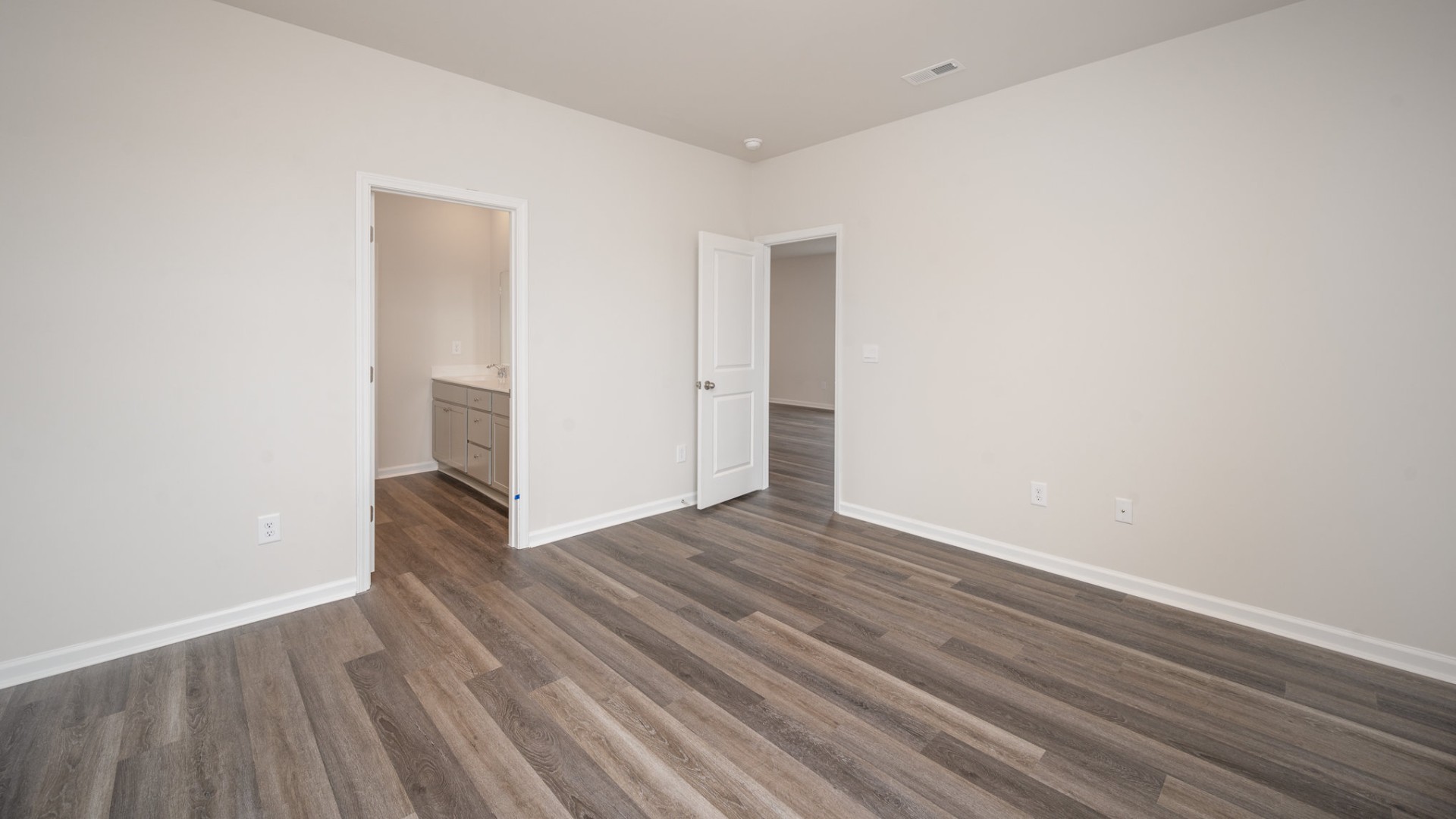 The primary bedroom suite and laundry room are conveniently located on the first floor, as well.