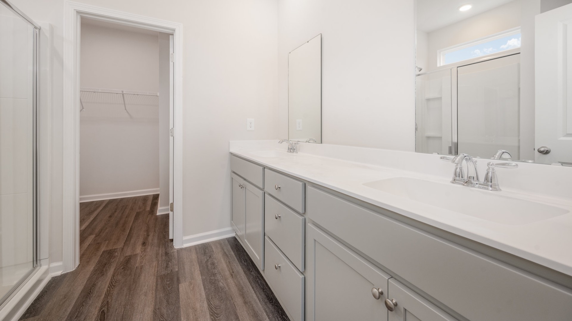 The primary bedroom suite and laundry room are conveniently located on the first floor, as well.