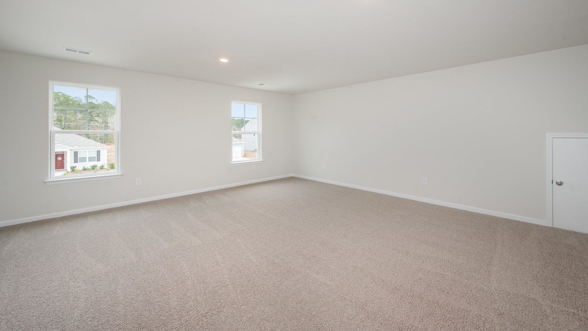 The primary bedroom suite and laundry room are conveniently located on the first floor, as well.