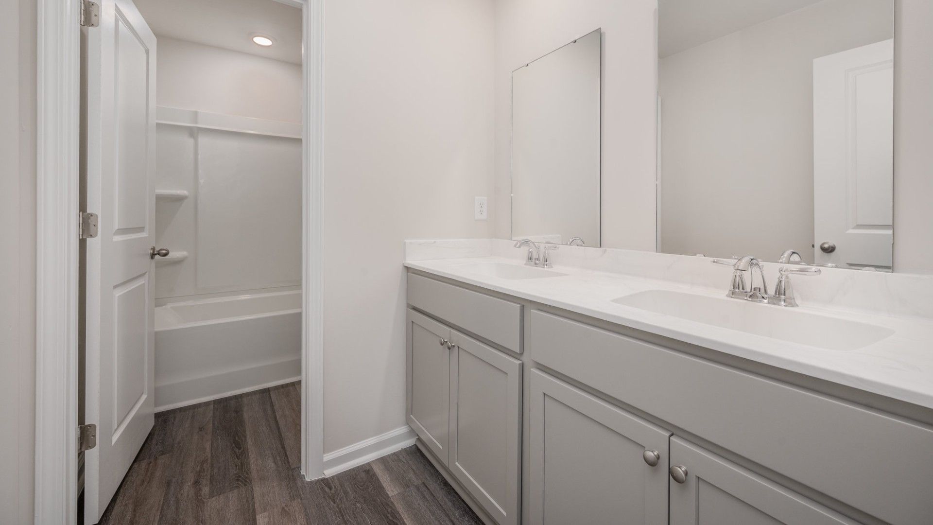 The primary bedroom suite and laundry room are conveniently located on the first floor, as well.