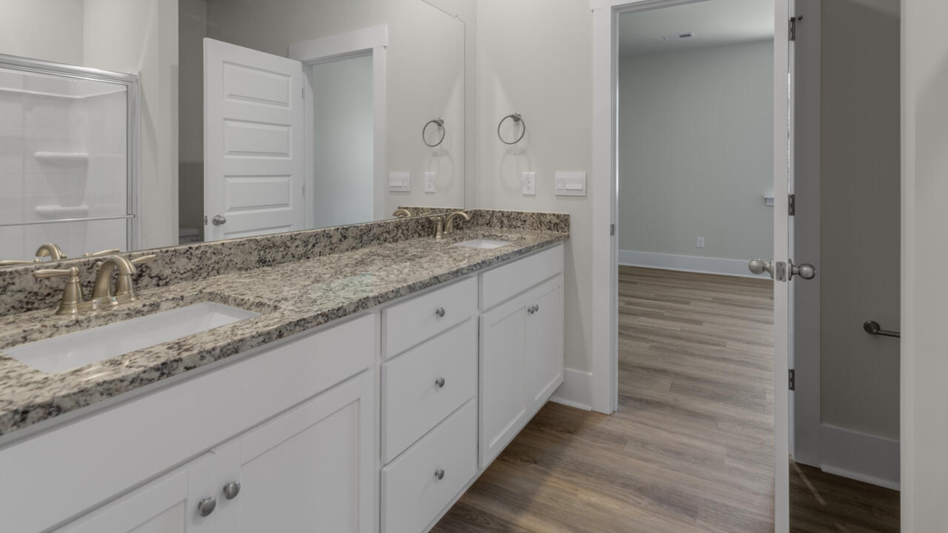 The primary bedroom suite and laundry room are conveniently located on the first floor, as well.