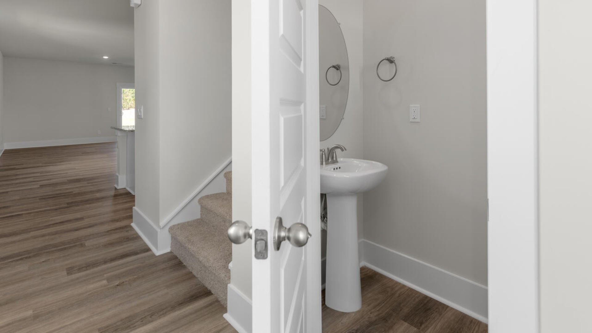 The primary bedroom suite and laundry room are conveniently located on the first floor, as well.