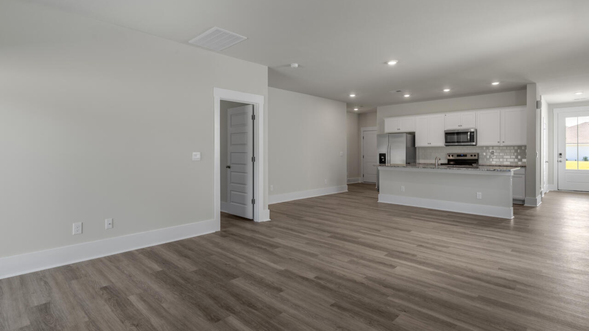 The primary bedroom suite and laundry room are conveniently located on the first floor, as well.