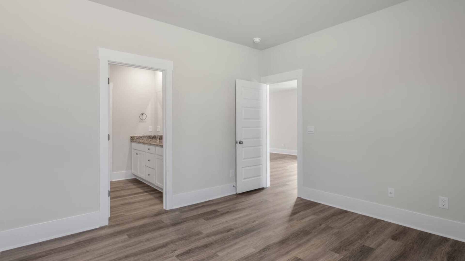 The primary bedroom suite and laundry room are conveniently located on the first floor, as well.