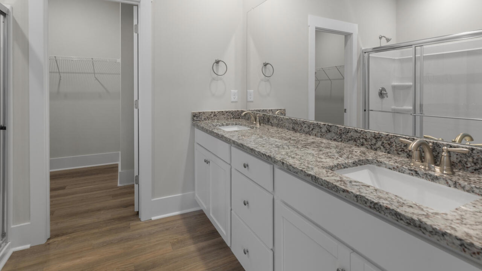 The primary bedroom suite and laundry room are conveniently located on the first floor, as well.