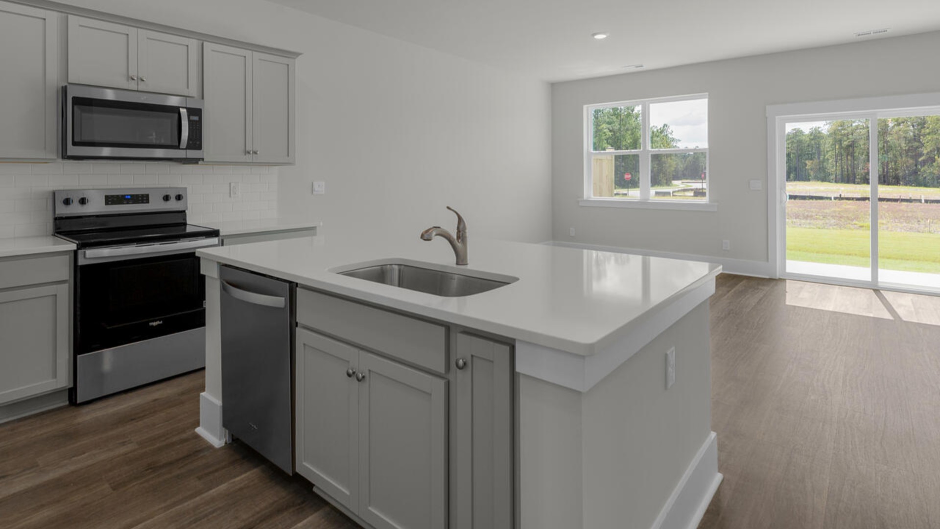The kitchen features granite countertops, stainless steel appliances and large island which are sure to both turn heads and make meal prep easy. You’ll never be too far from the action with the living and dining area right there