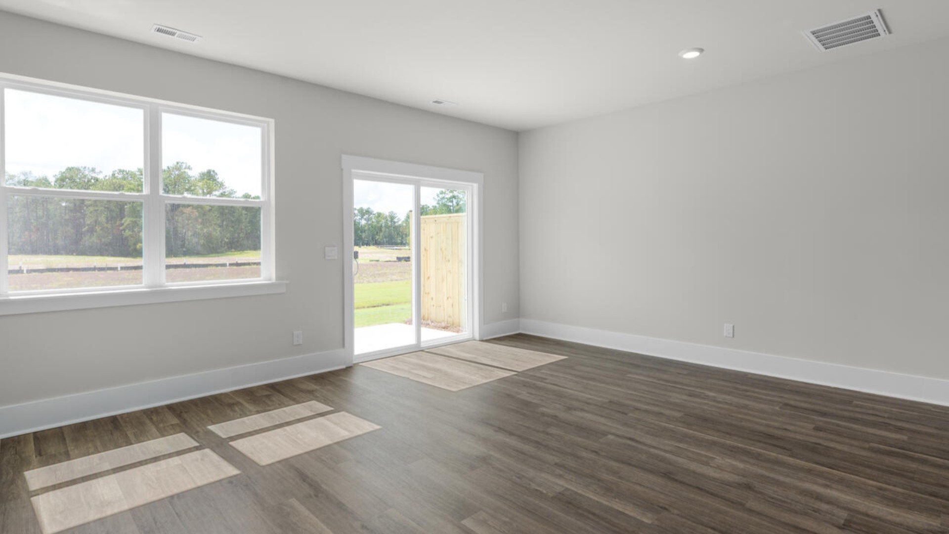 There is a powder room located under the stairs. The living area is an open concept, where your kitchen, living, and dining areas blend seamlessly into a space perfect for everyday living and entertaining.