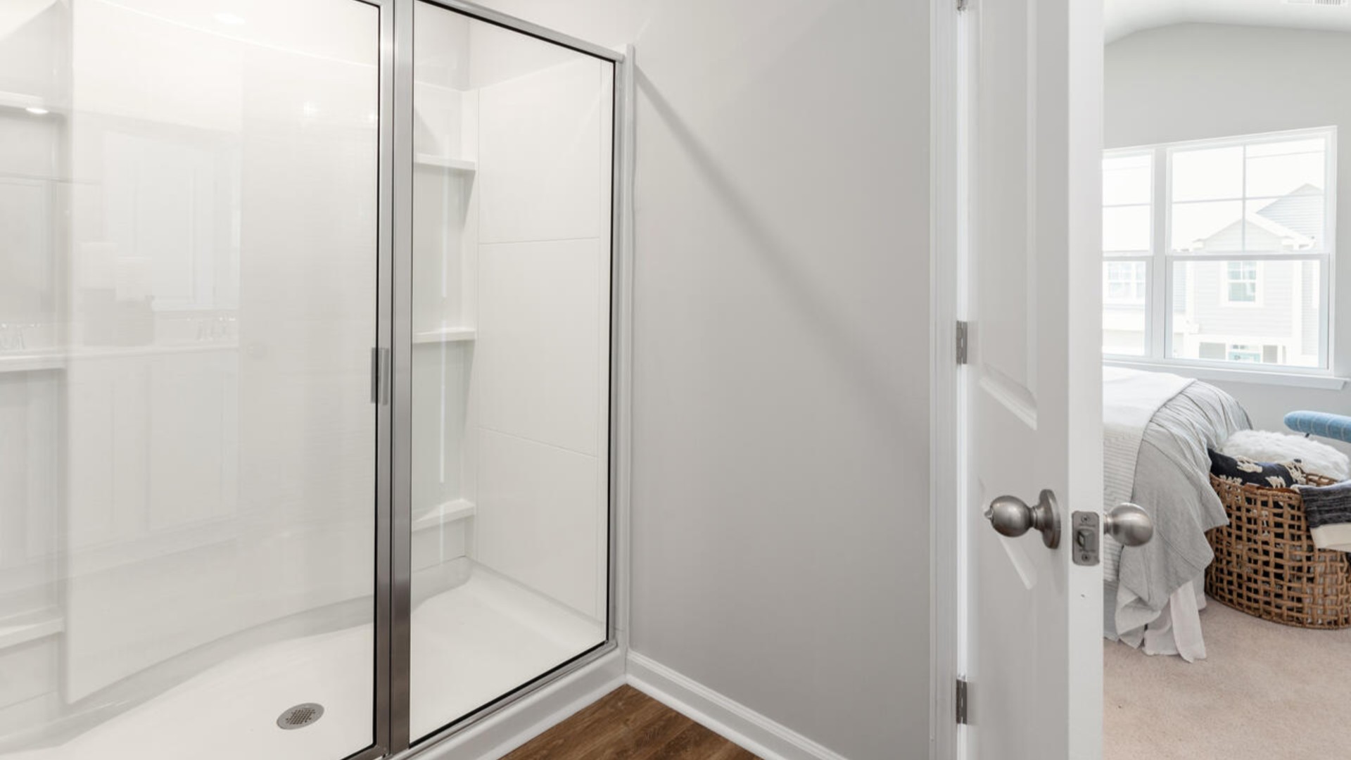 Upstairs, you'll find a generous primary suite featuring a walk-in closet, along with two additional guest bedrooms and a shared full bath, perfect for family or flexible living space. This thoughtfully designed layout provides the privacy you need with all the function you want.
