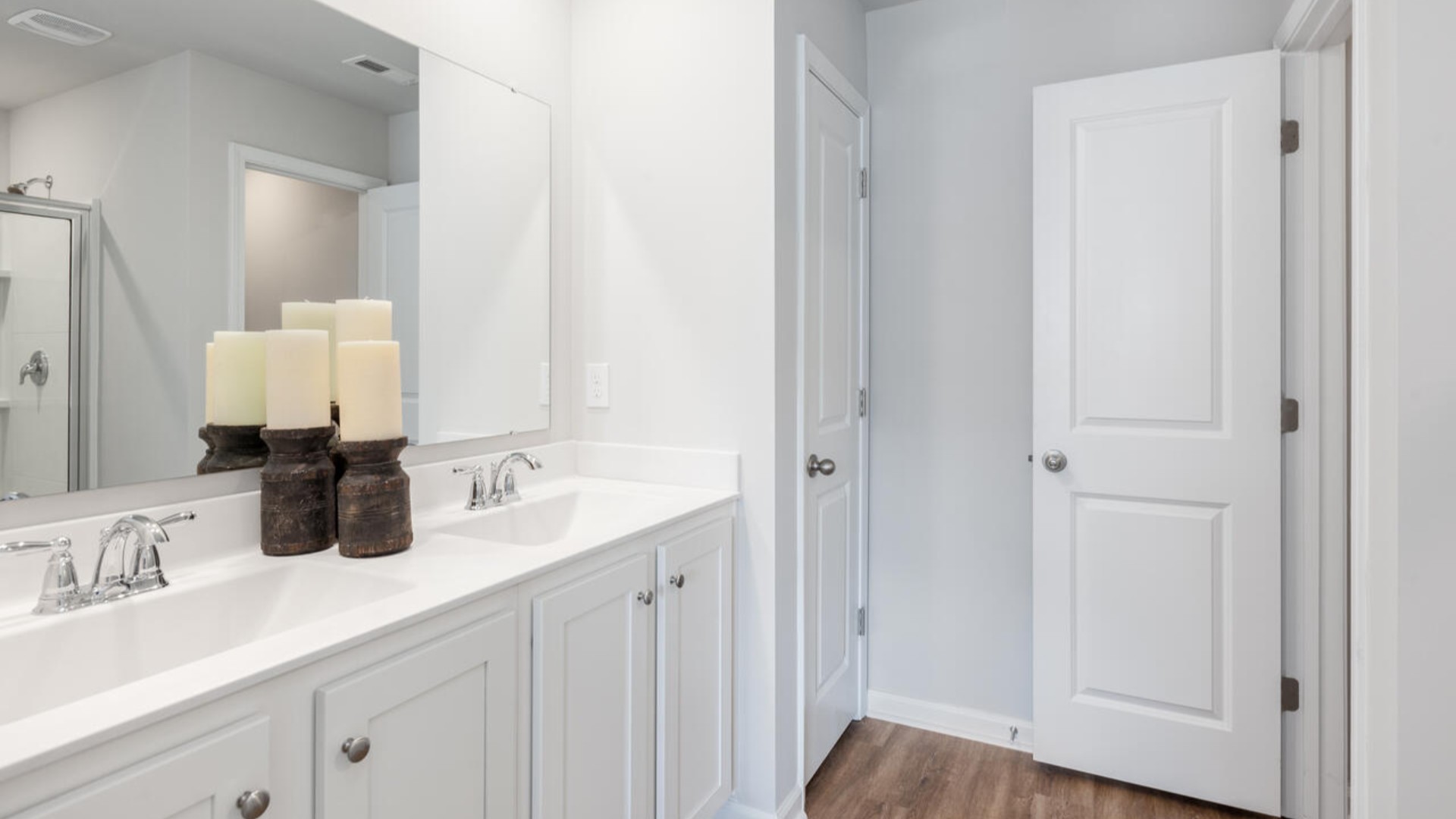 Upstairs, you'll find a generous primary suite featuring a walk-in closet, along with two additional guest bedrooms and a shared full bath, perfect for family or flexible living space. This thoughtfully designed layout provides the privacy you need with all the function you want.