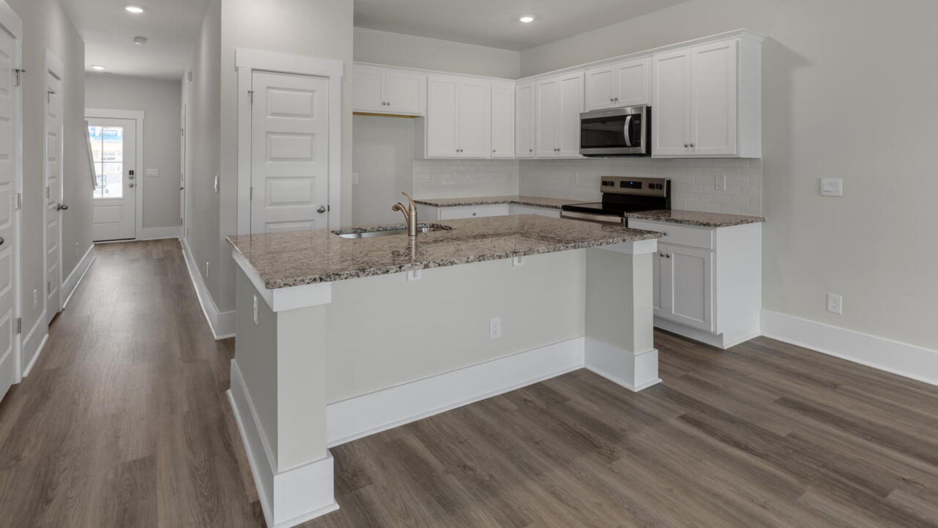 The kitchen features granite countertops, stainless steel appliances and large island which are sure to both turn heads and make meal prep easy. You’ll never be too far from the action with the living and dining area right there.