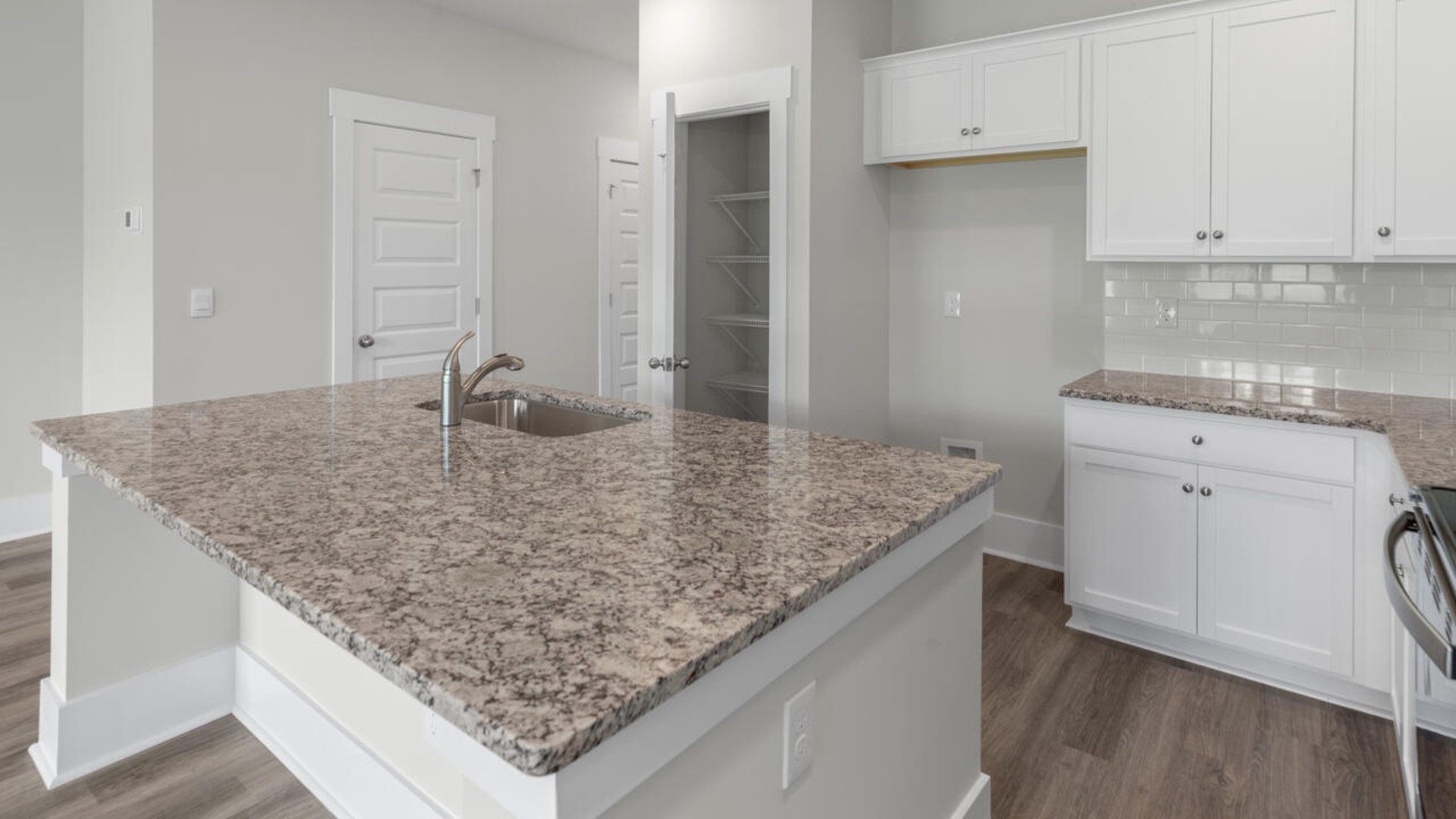 The kitchen features granite countertops, stainless steel appliances and large island which are sure to both turn heads and make meal prep easy. You’ll never be too far from the action with the living and dining area right there.