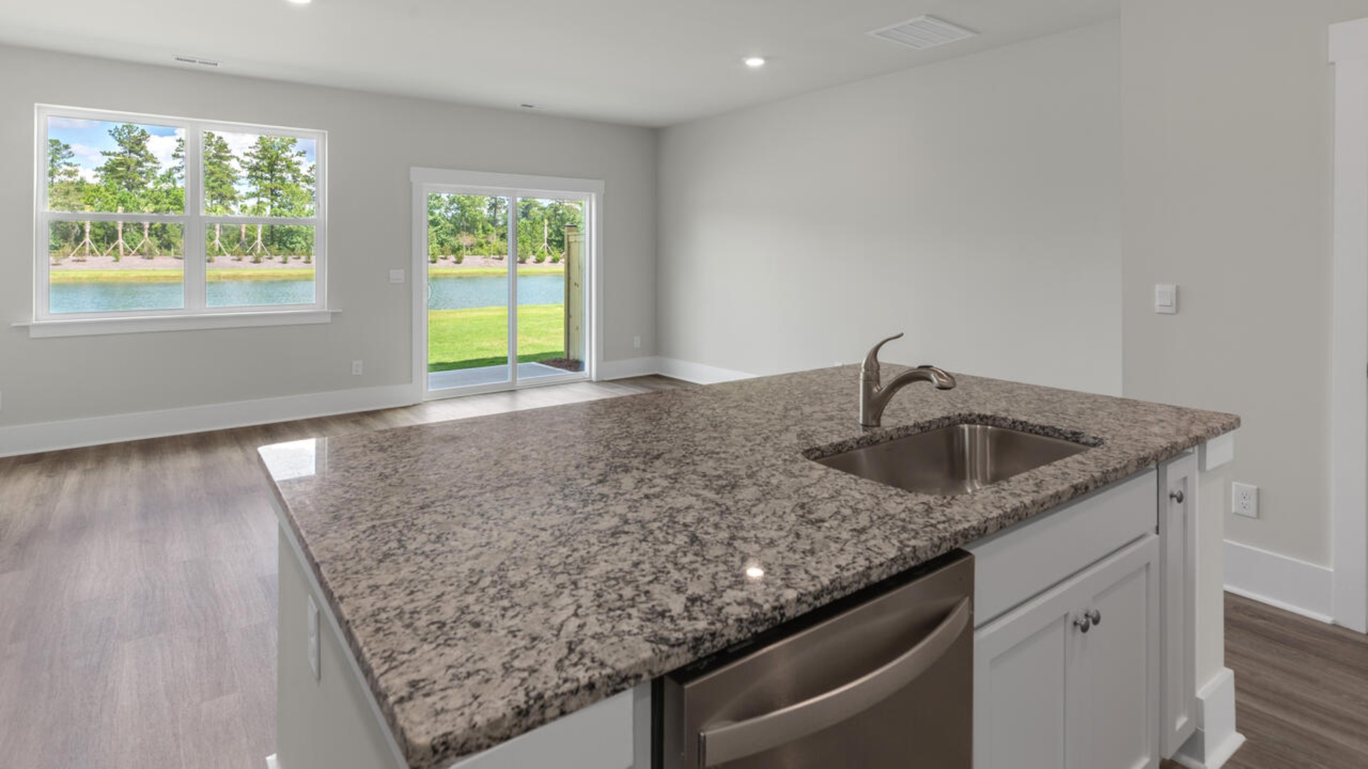 The kitchen features granite countertops, stainless steel appliances and large island which are sure to both turn heads and make meal prep easy. You’ll never be too far from the action with the living and dining area right there.