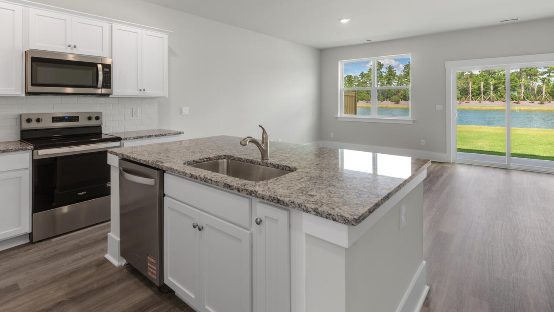 The kitchen features granite countertops, stainless steel appliances and large island which are sure to both turn heads and make meal prep easy. You’ll never be too far from the action with the living and dining area right there.