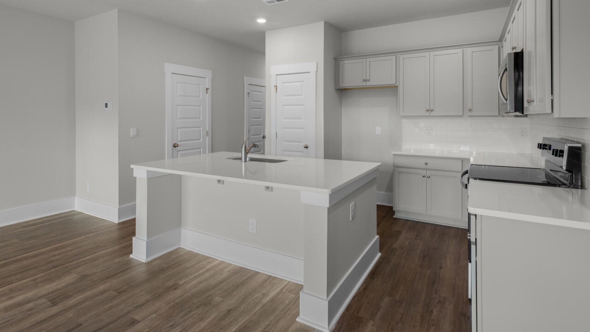 The kitchen features shaker-style cabinets, granite countertops, and stainless steel appliances, which are sure to both turn heads and make meal prep easy.