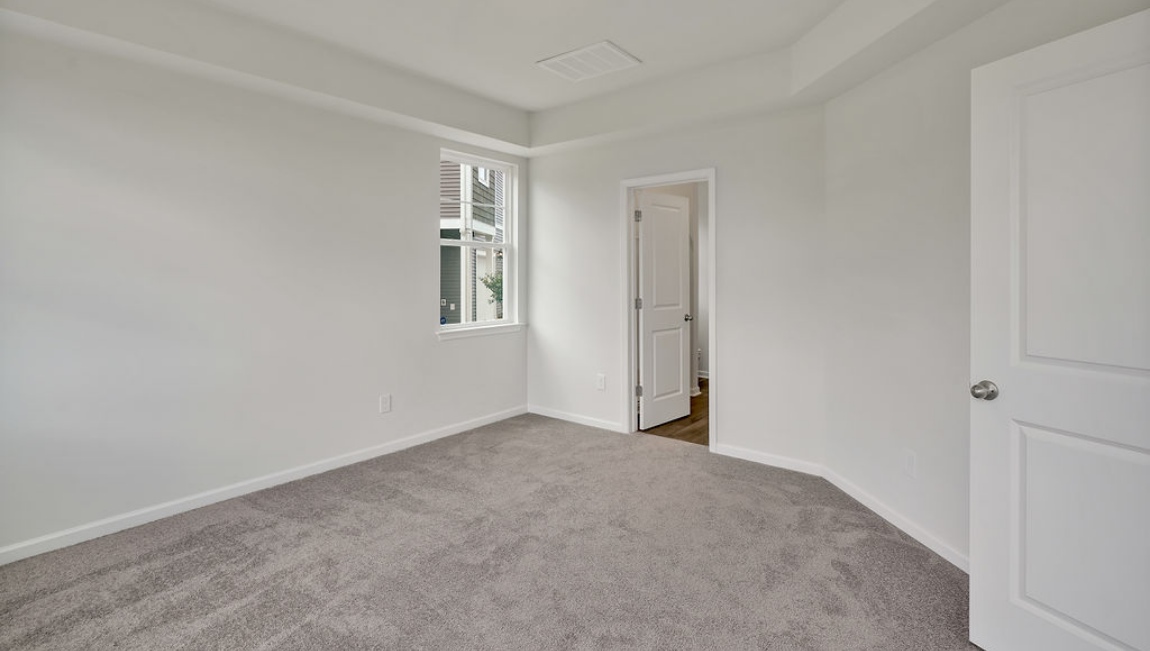 The open concept living room off the kitchen offers a feeling of grandeur with it's two-story ceiling