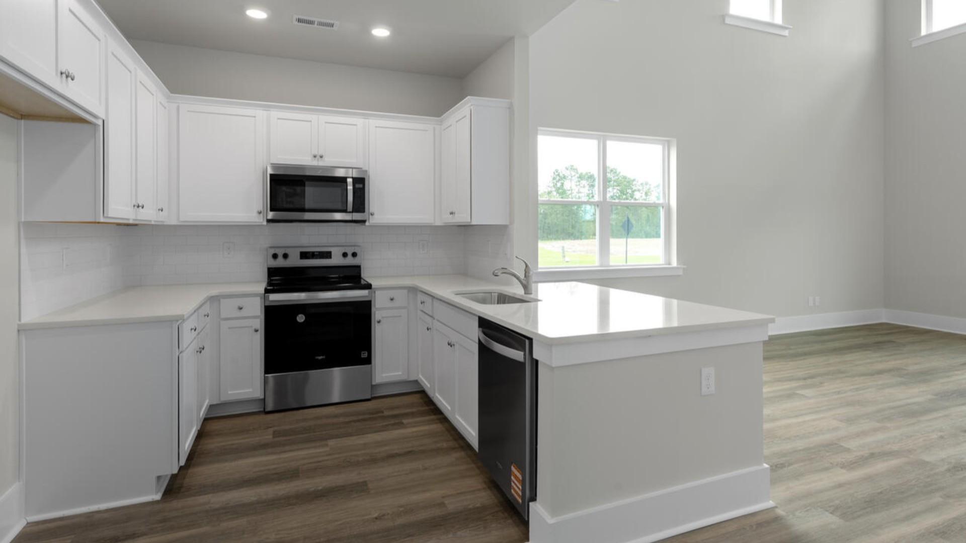 The open concept living space is anchored by a spacious kitchen with granite countertops, stainless steel appliances and a large island that overlooks your family and dining room. Ideal for entertaining guests or enjoying family time while preparing meals.