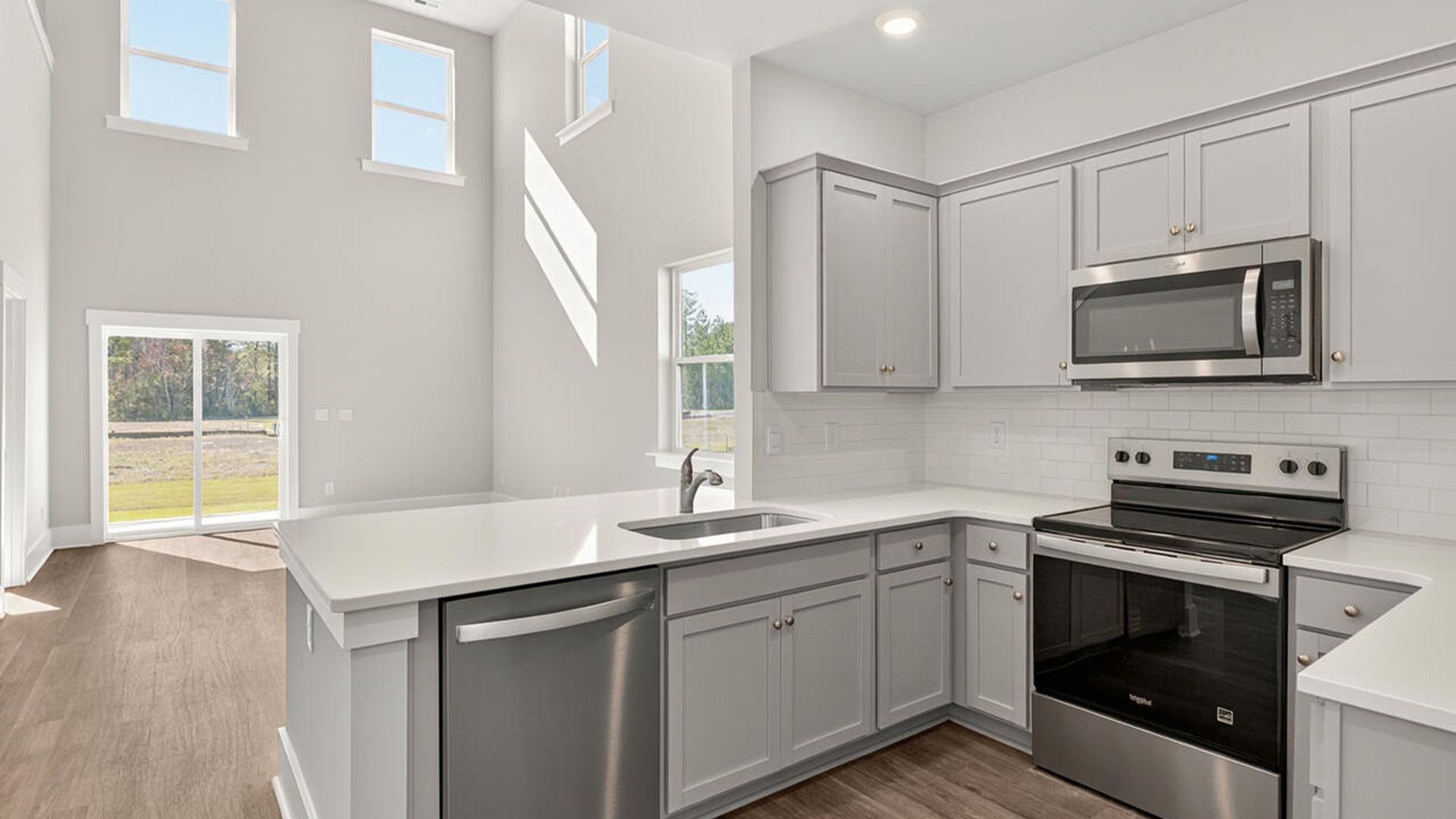 The open concept living room off the kitchen offers a feeling of grandeur