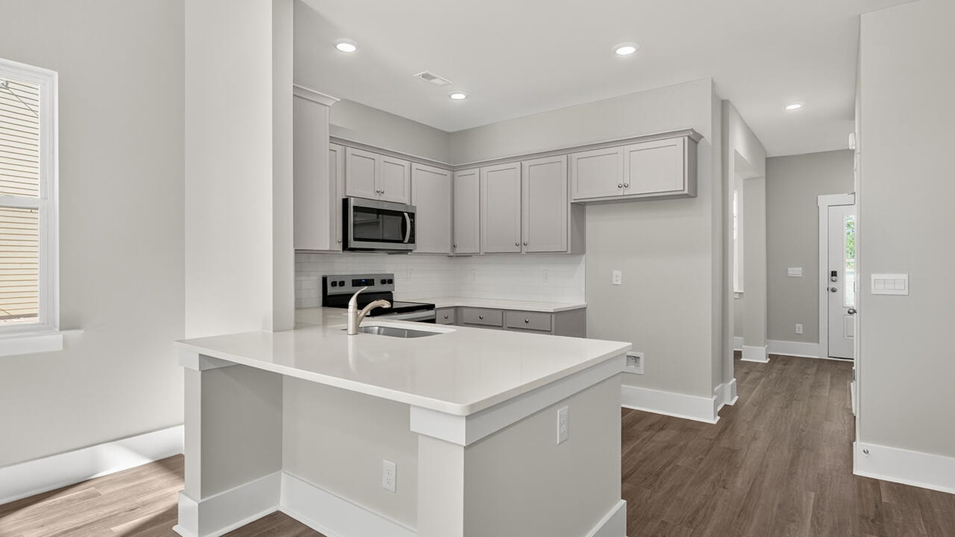 The open concept living room off the kitchen offers a feeling of grandeur
