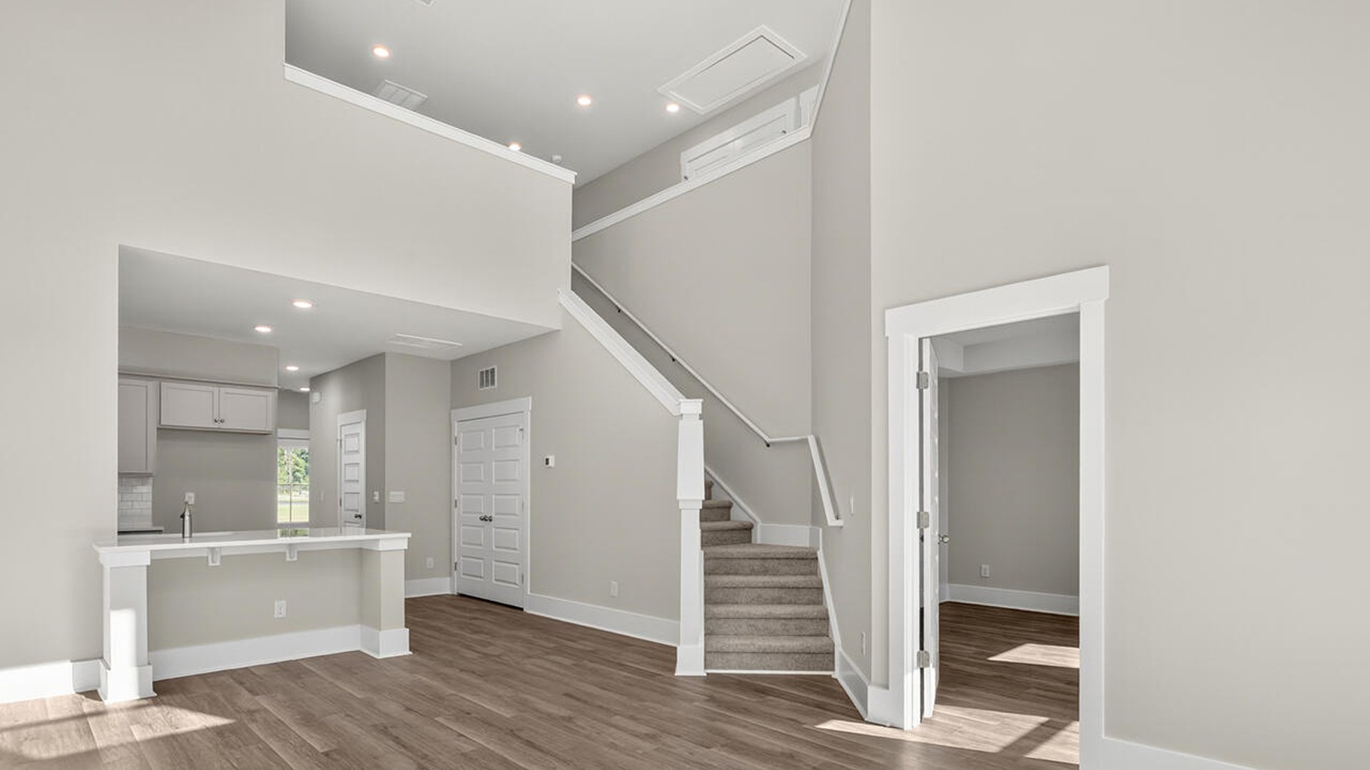 The open concept living room off the kitchen offers a feeling of grandeur with it's two-story ceilings and so much natural light to take in.