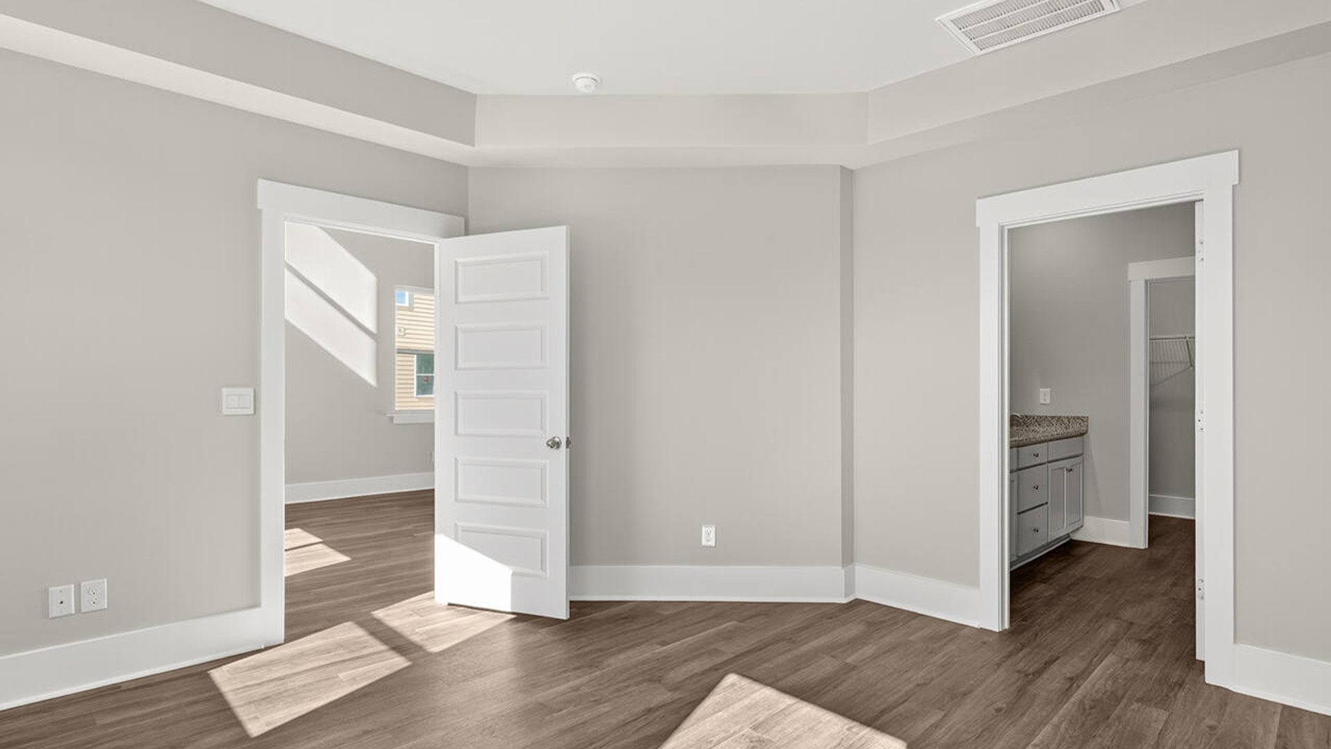 The first-floor primary bedroom boasts a large bath, double vanities and walk-in closet and convenient laundry room.