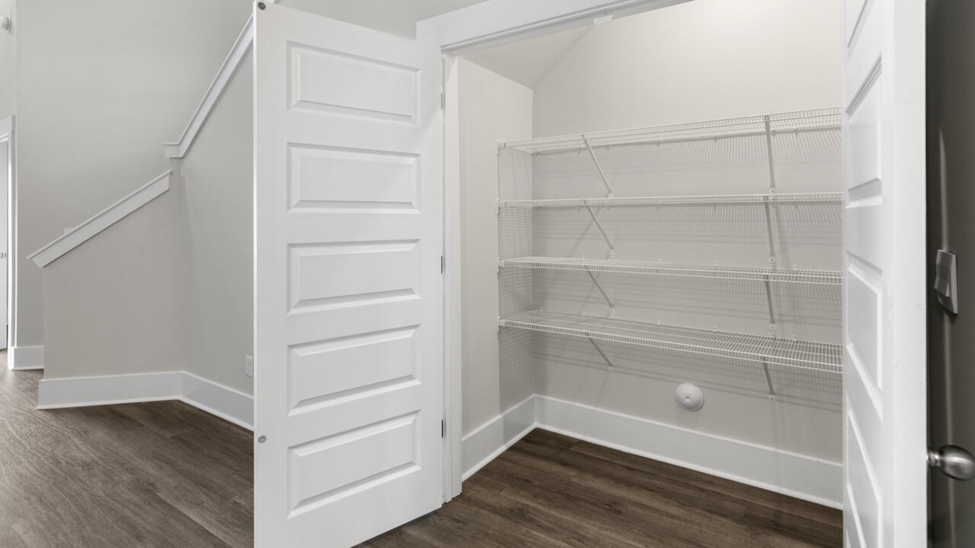 The kitchen features shaker-style cabinets, quartz countertops, and stainless-steel appliances, which are sure to both turn heads and make meal prep easy. You’ll never be too far from the action with the living and dining area right there.