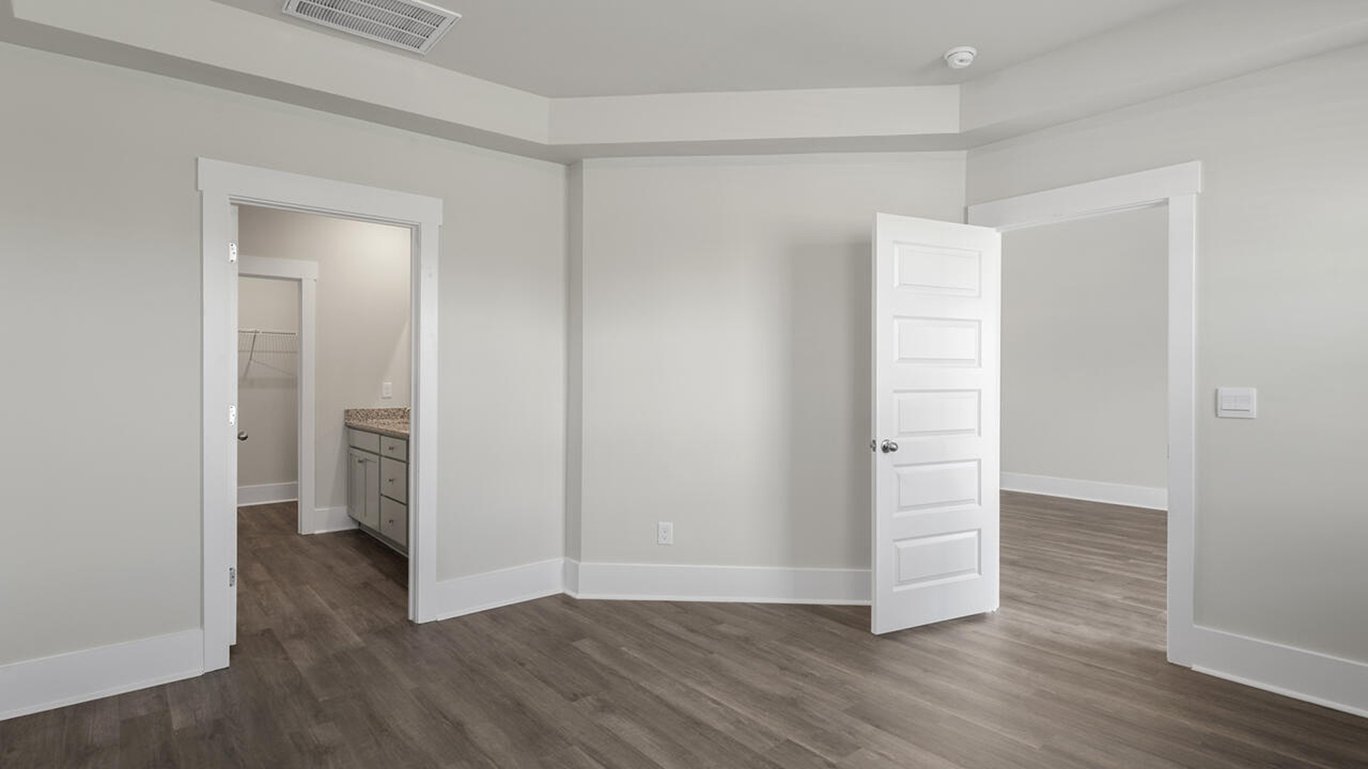 The first-floor primary bedroom boasts a large bath and walk-in closet.