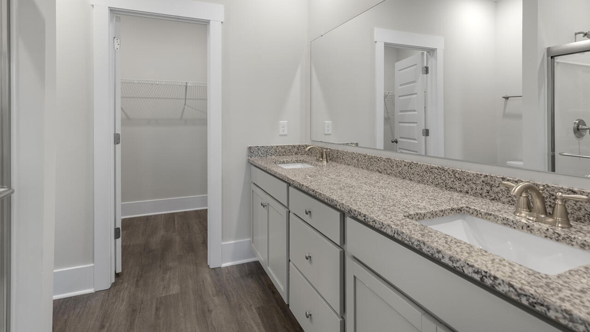 The first-floor primary bedroom boasts a large bath and walk-in closet.