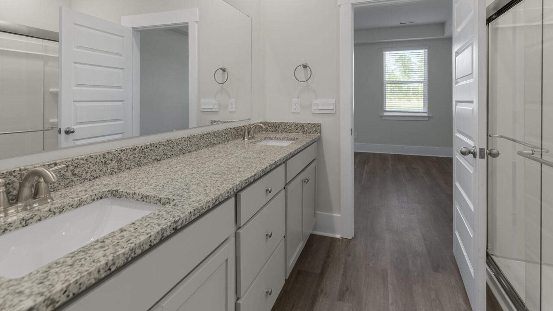 The first-floor primary bedroom boasts a large bath and walk-in closet.