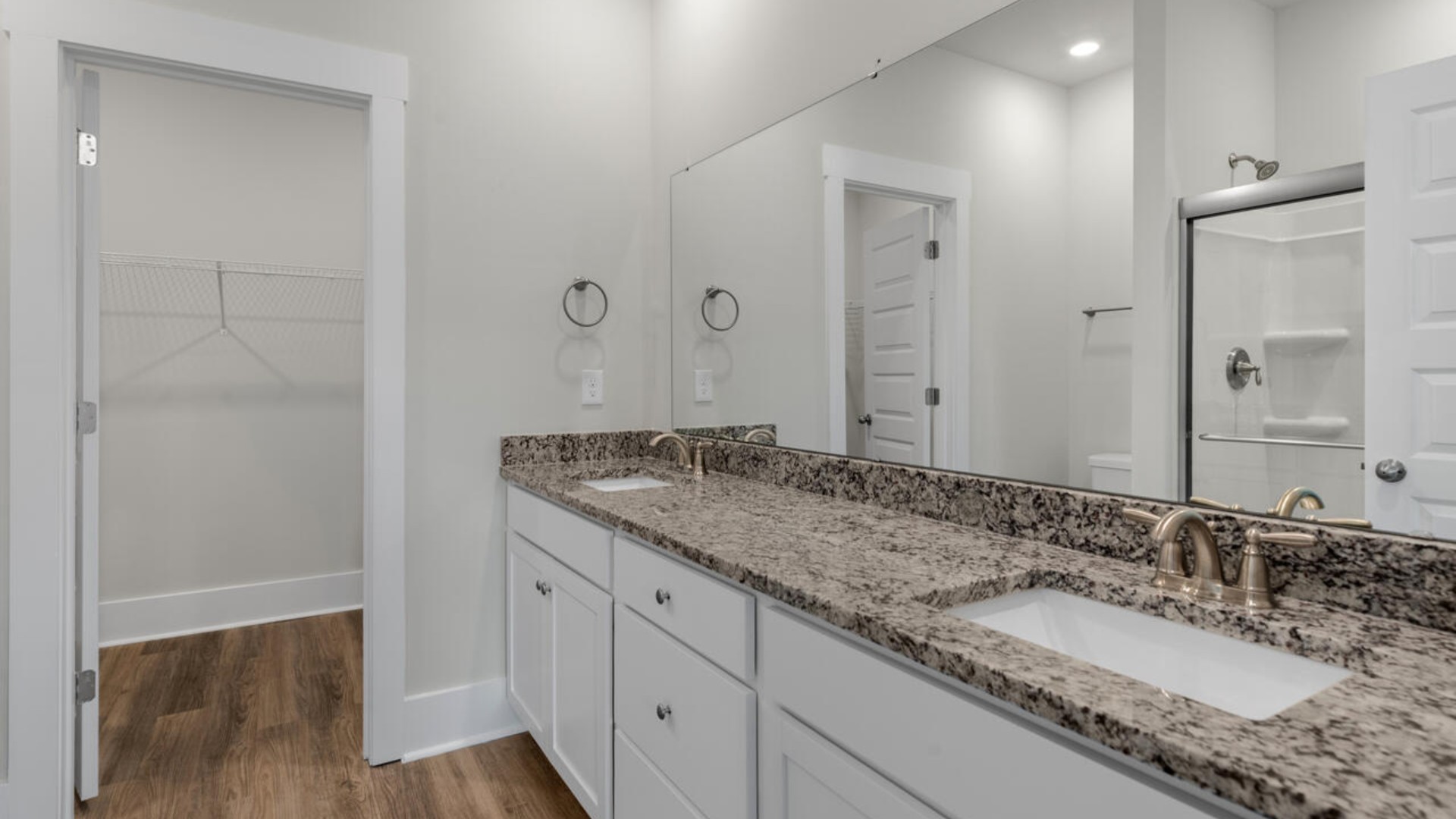 The first-floor primary bedroom boasts a large bath and walk-in closet.