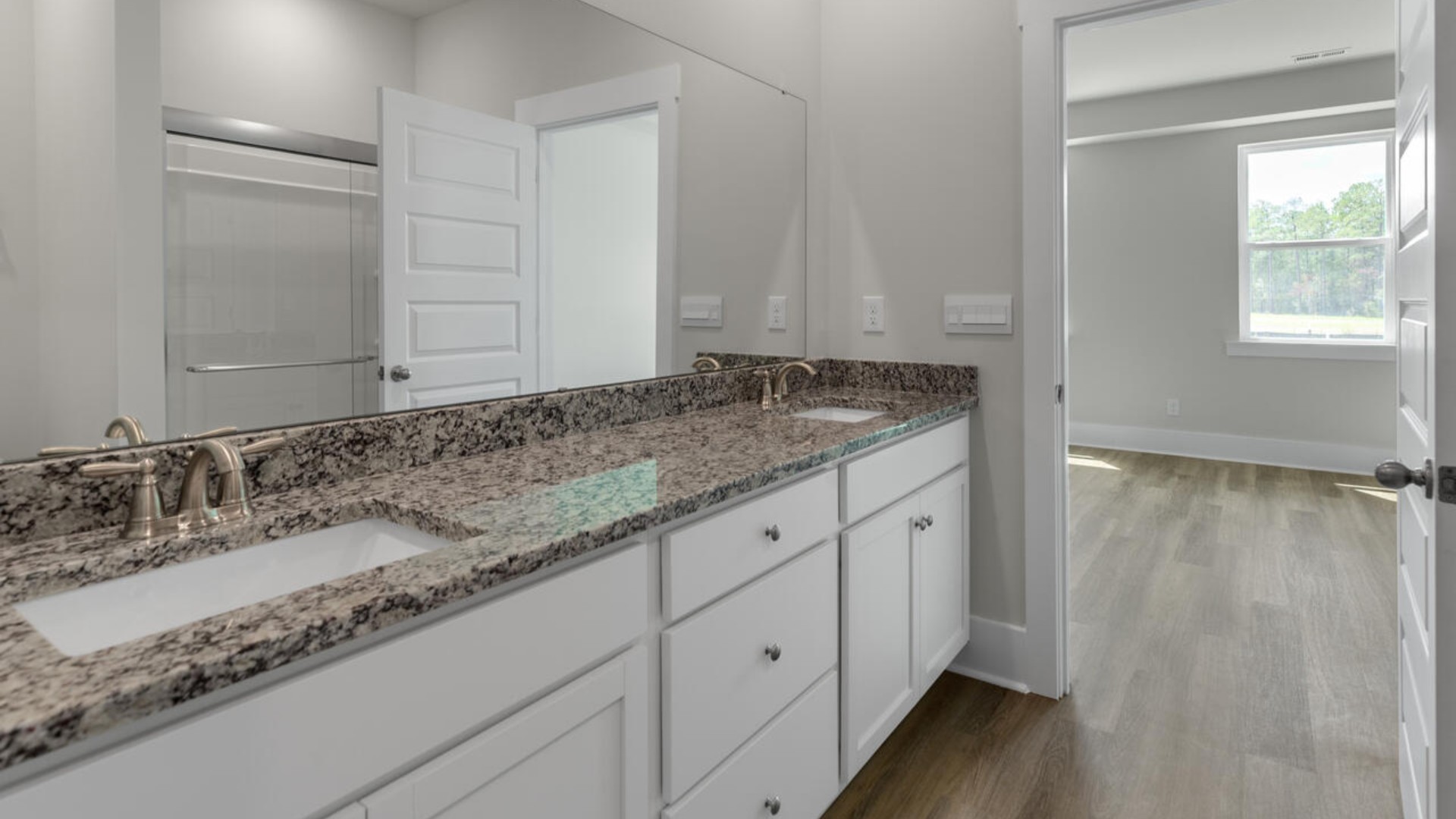 The first-floor primary bedroom boasts a large bath and walk-in closet.