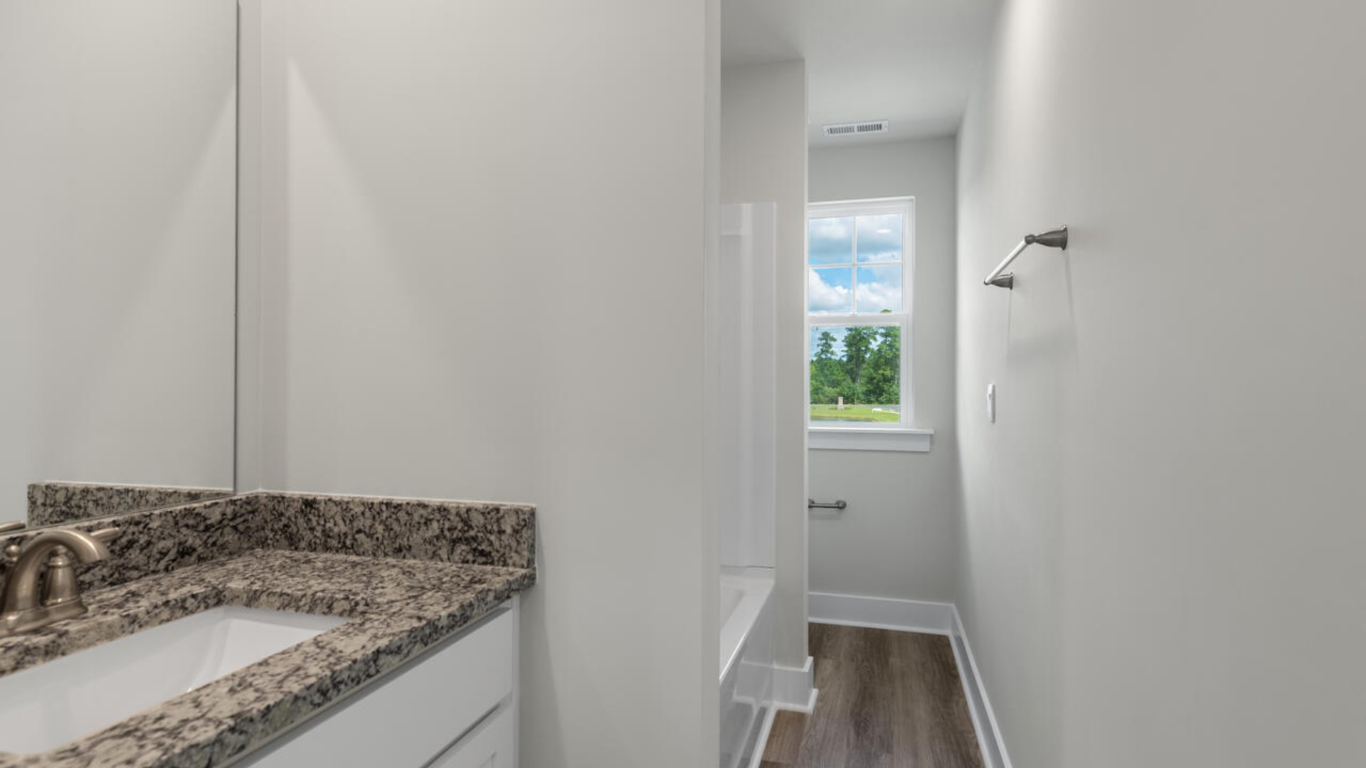 On the second floor, you are greeted by a two additional bedrooms, full bathroom, versatile loft space, and laundry room.