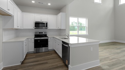 The Marion floorplan features an inviting covered front porch that opens into a formal dining room. The open concept living space is anchored by a spacious kitchen with granite countertops, stainless steel appliances and a large island that overlooks your family and dining room. Ideal for entertaining guests or enjoying family time while preparing meals.