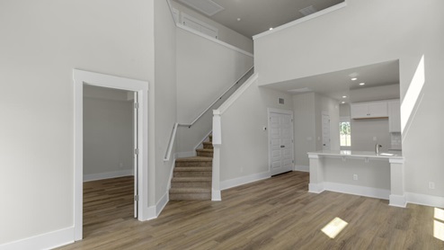 The Marion floorplan features an inviting covered front porch that opens into a formal dining room. The open concept living space is anchored by a spacious kitchen with granite countertops, stainless steel appliances and a large island that overlooks your family and dining room. Ideal for entertaining guests or enjoying family time while preparing meals.