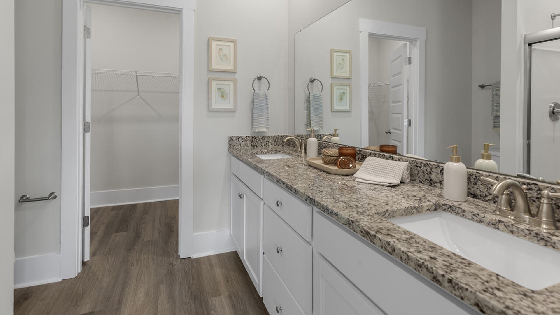 The first-floor primary bedroom boasts a large bath, double vanities and walk-in closet and convenient laundry room. On the second floor, you are greeted by a versatile loft space, two secondary bedrooms, laundry and a full bath.