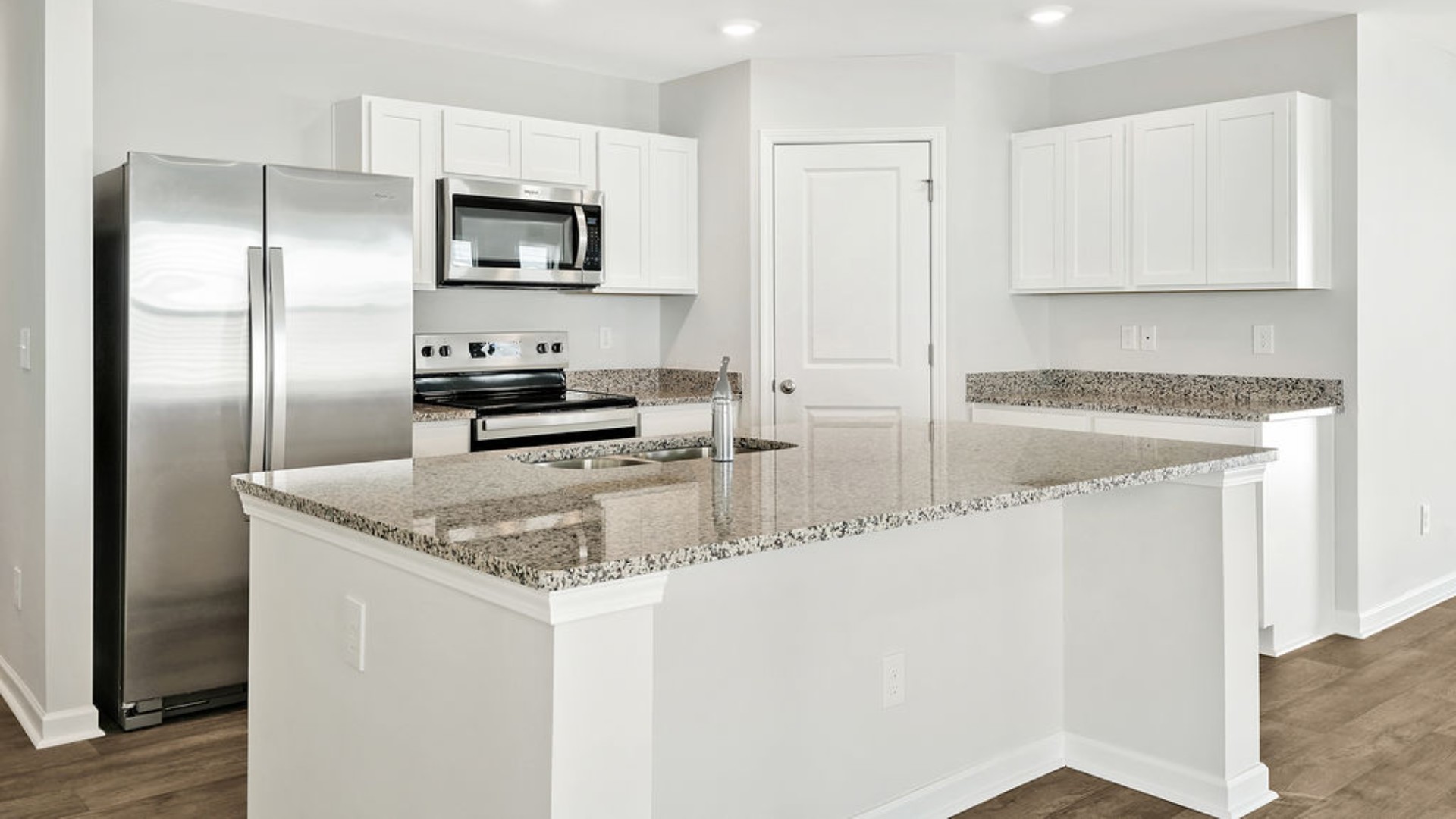 The kitchen features granite countertops, and stainless steel appliances, which are sure to both turn heads and make meal prep easy. You’ll never be too far from the action with the living and dining area right there.